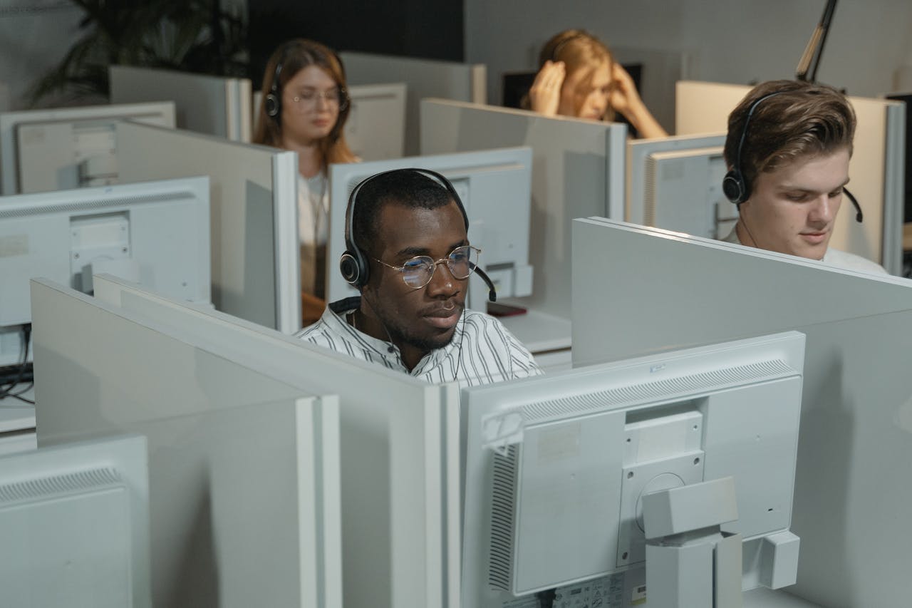 Focused call center agents working in an office environment, providing customer support.